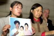 Holding a picture of her late-husband, Jane Dai tells the press how her husband was tortured to death in China because he did not renounce his belief in Falun Gong's principles: